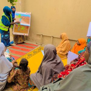 Facilitator with women leaders during Sensitization Session at Hausari Community