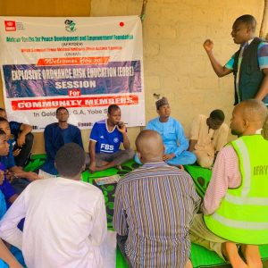Facilitator with youths during Sensitization Session at Hausari Community
