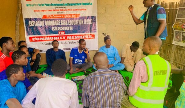 Facilitator with youths during Sensitization Session at Hausari Community